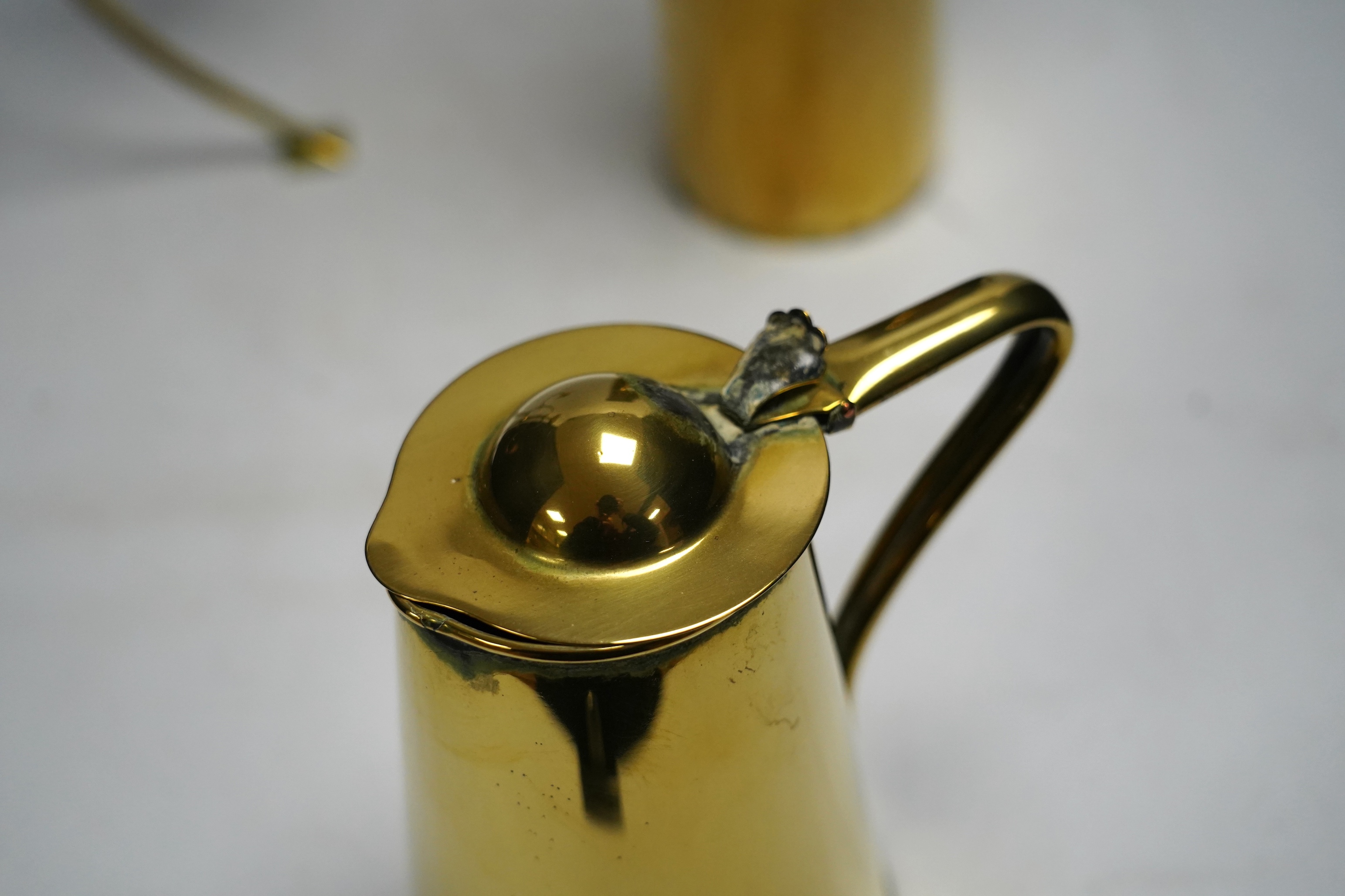 Two brass ewers in Arts and Crafts style and a similar candelabra, 39cm